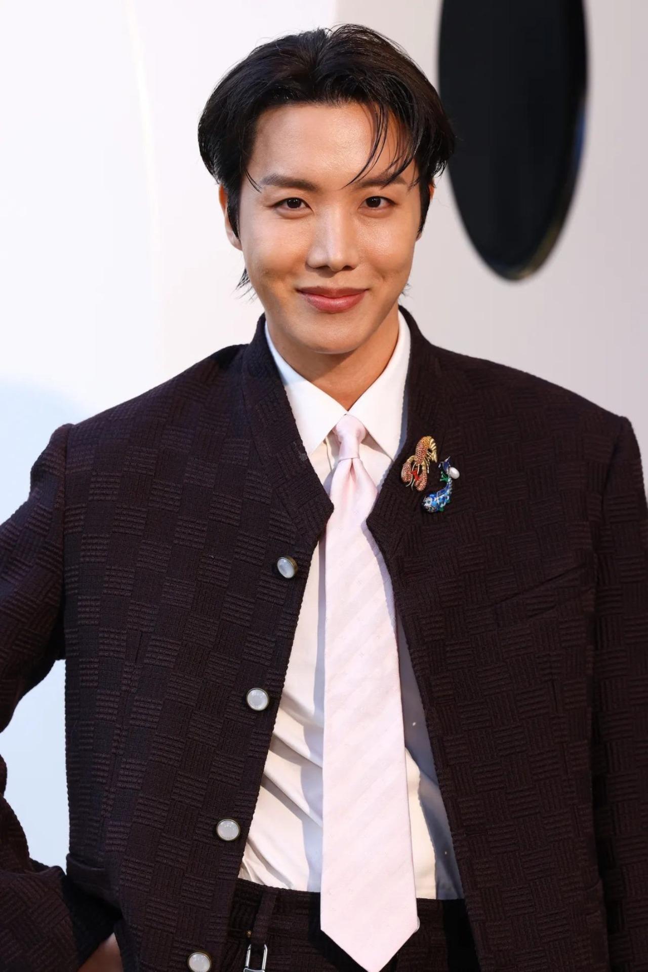 J-Hope in a contextual photograph: Louis Vuitton Paris Fashion Week portrait; contextual photograph, not tattoo evidence; not tattoo evidence
