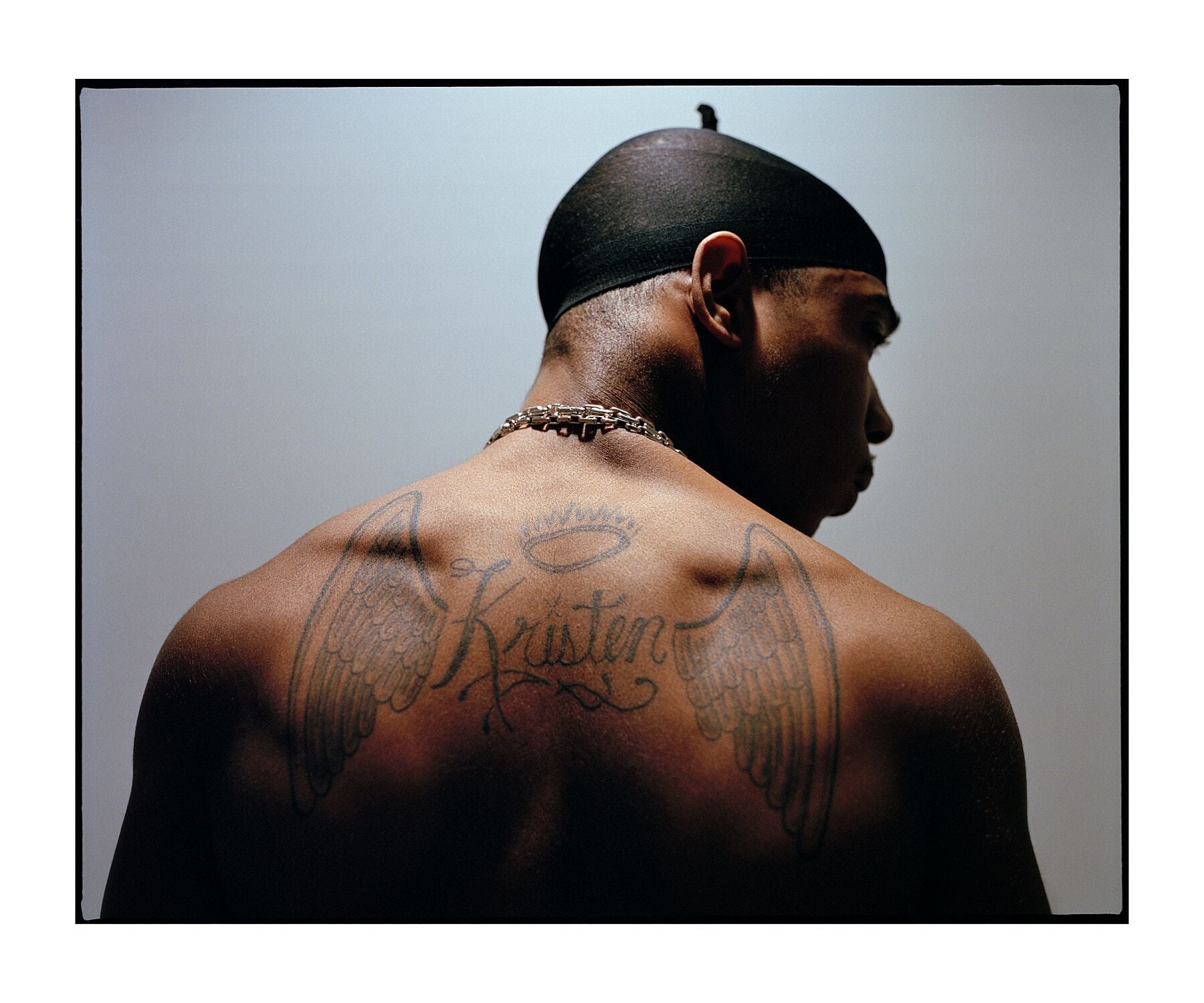 Ja Rule tattoos: high-resolution back portrait showing the angel wings, halo, name lettering and cross imagery