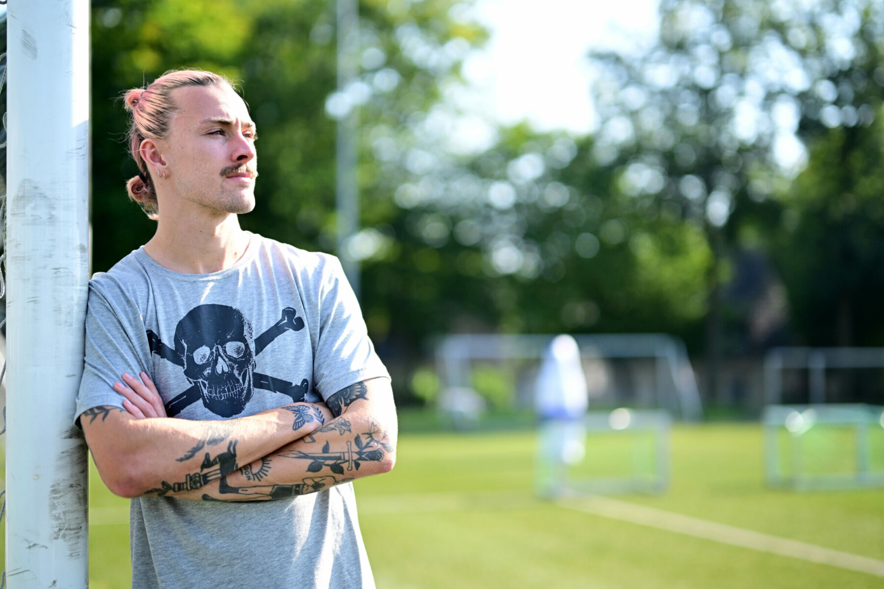 Jackson Irvine A second, separately shot arms-crossed portrait from the same editorial gallery; tattoos remain visibly distinct in pose and framing from the previous image. Jackson Irvine tattoos: A second, separately shot arms-crossed portrait from the same editorial gallery; tattoos remain visibly distinct in pose and framing from the previous image.