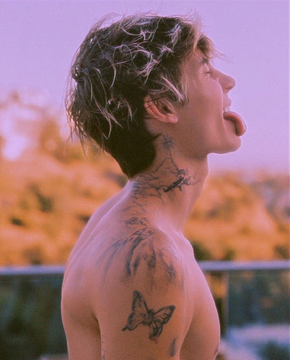 Jaden Hossler showing his butterfly shoulder tattoo