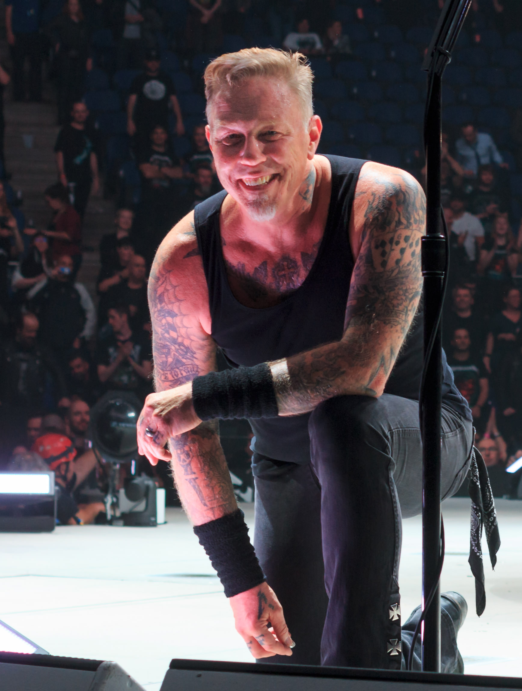 James Hetfield showing full arm tattoos on stage