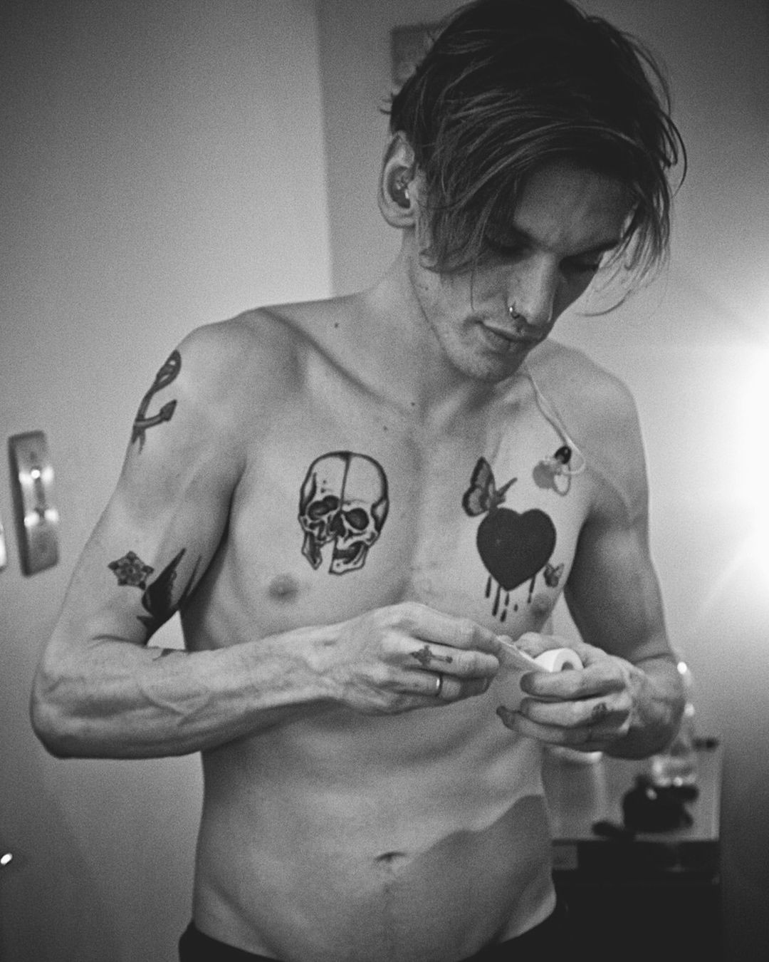 The skull and black heart across the chest Jamie Campbell Bower tattoos: The skull and black heart across the chest