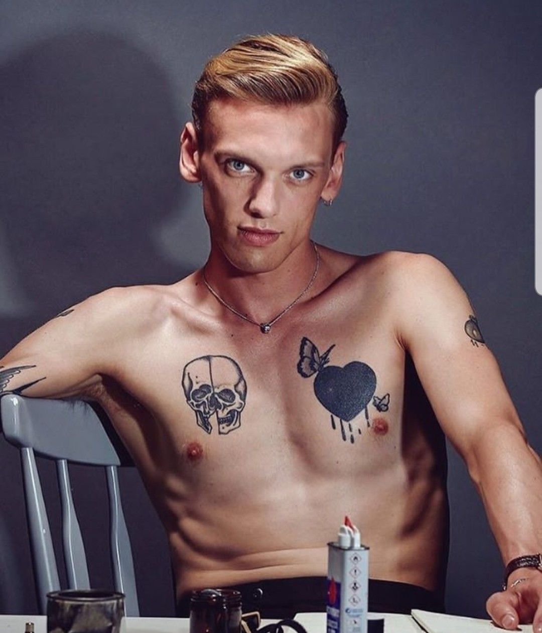 The skull, heart and shoulder ink in a seated portrait Jamie Campbell Bower tattoos: The skull, heart and shoulder ink in a seated portrait