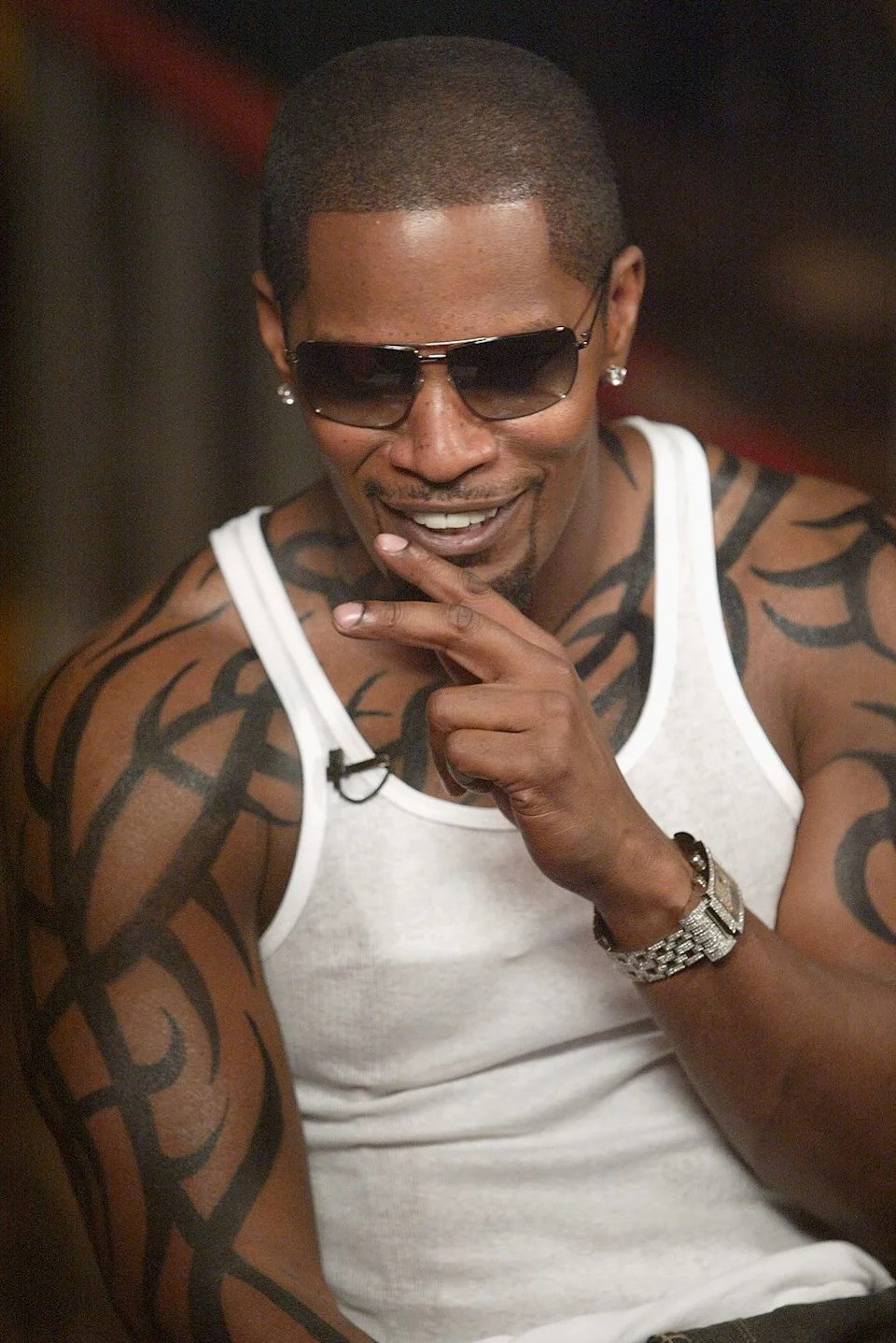 Jamie Foxx tattoos: high-resolution portrait showing the broad black tattoo field across Foxx’s shoulders and upper arms