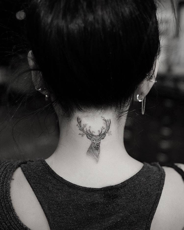 Janel Parrish tattoos: wider placement view of the deer tattoo below the hairline