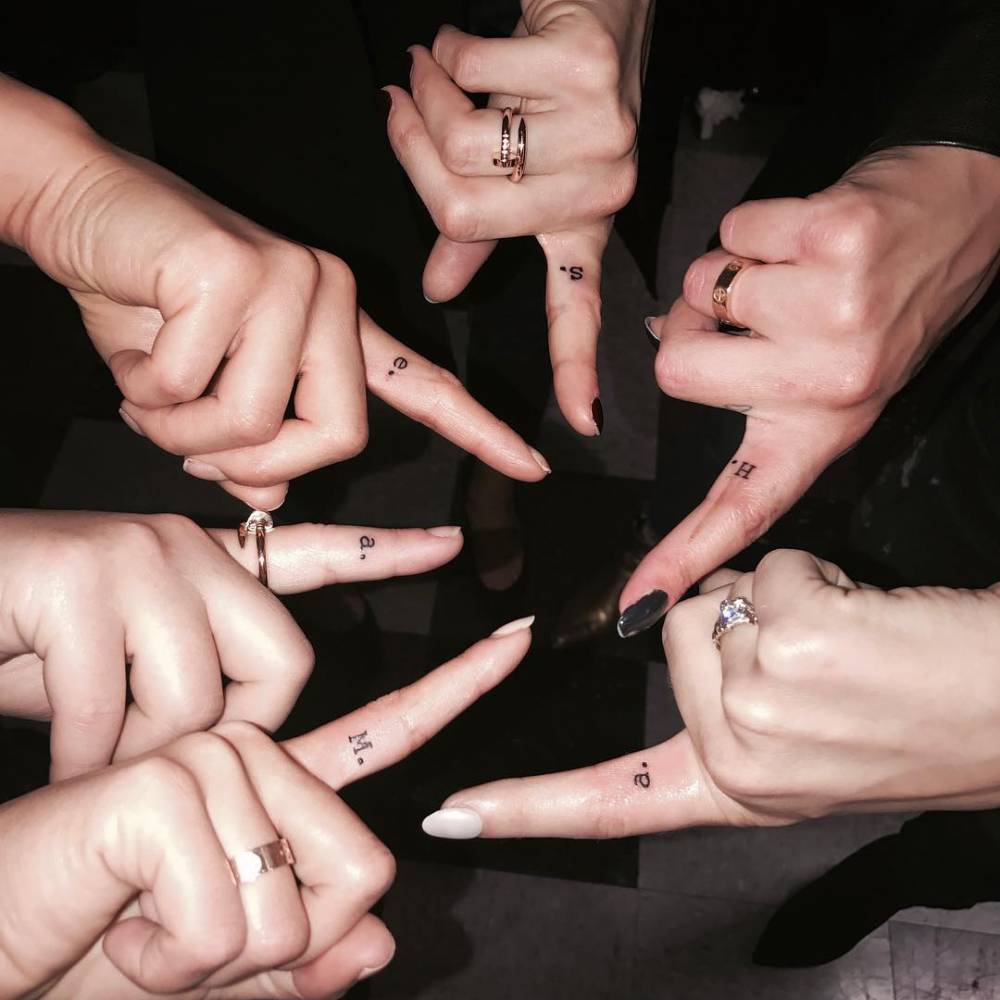 Janel Parrish tattoos: Pretty Little Liars character initials and tiny finger lettering