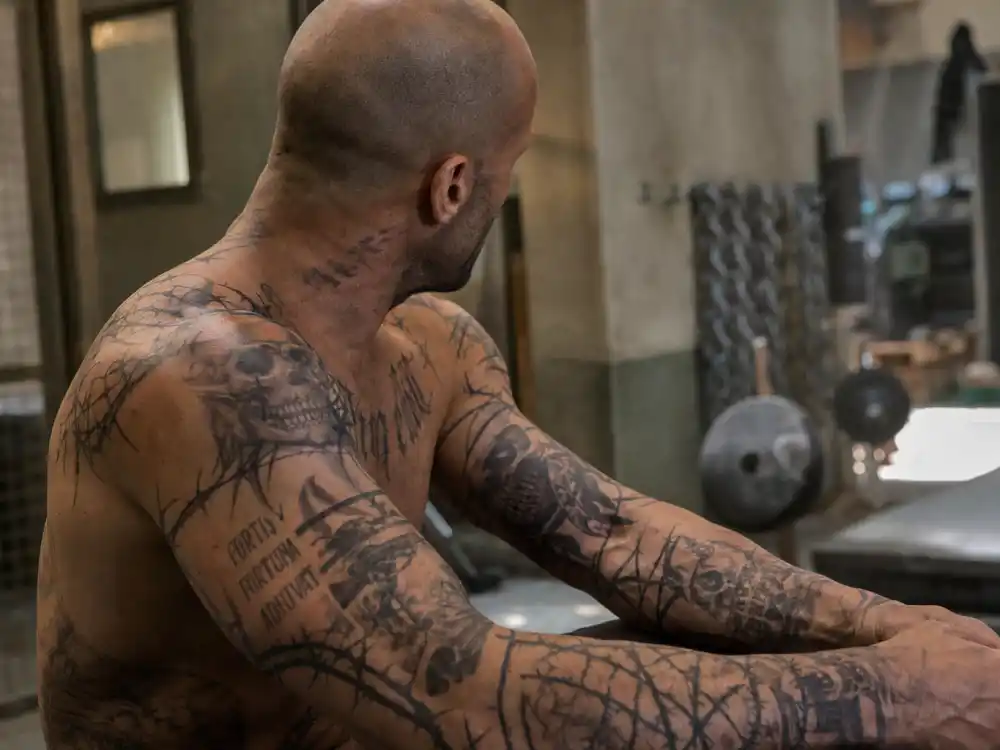 Jason Statham tattoos: close film still showing the Death Race tribal tattoo makeup across the shoulders and arms