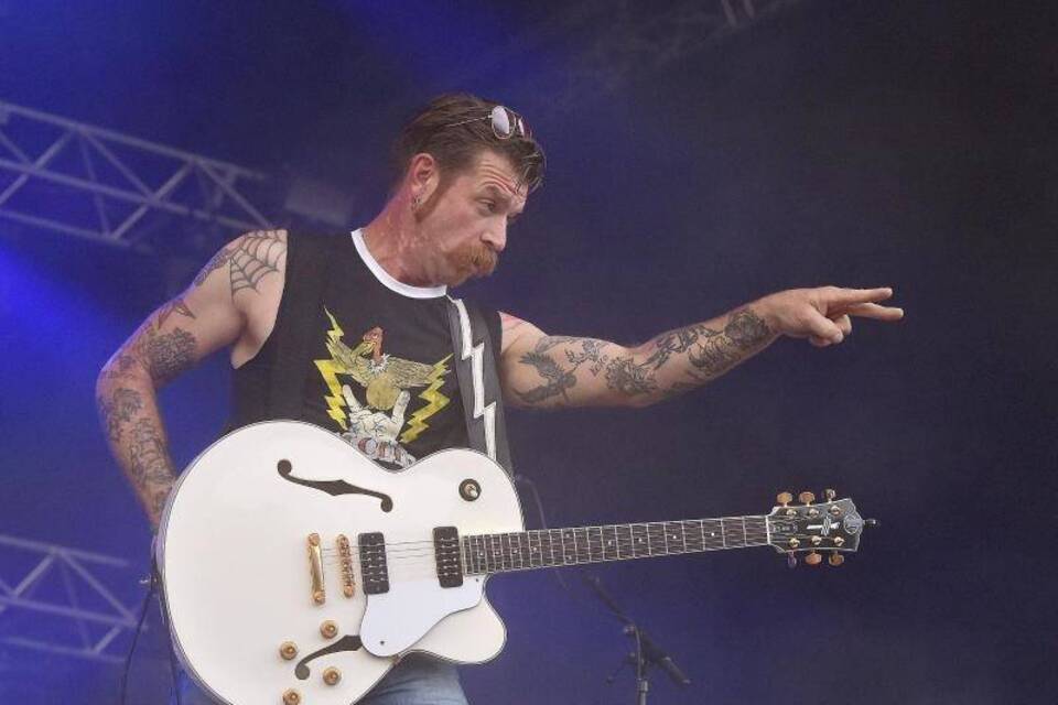 Jesse Hughes full arm tattoo collection on stage