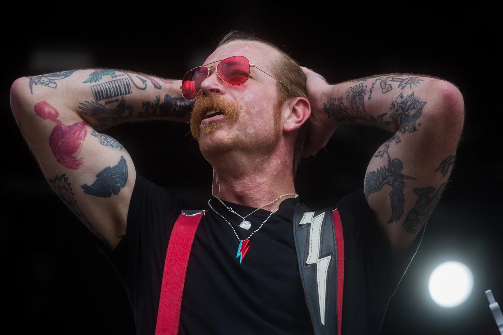 Jesse Hughes colorful arm tattoos on stage
