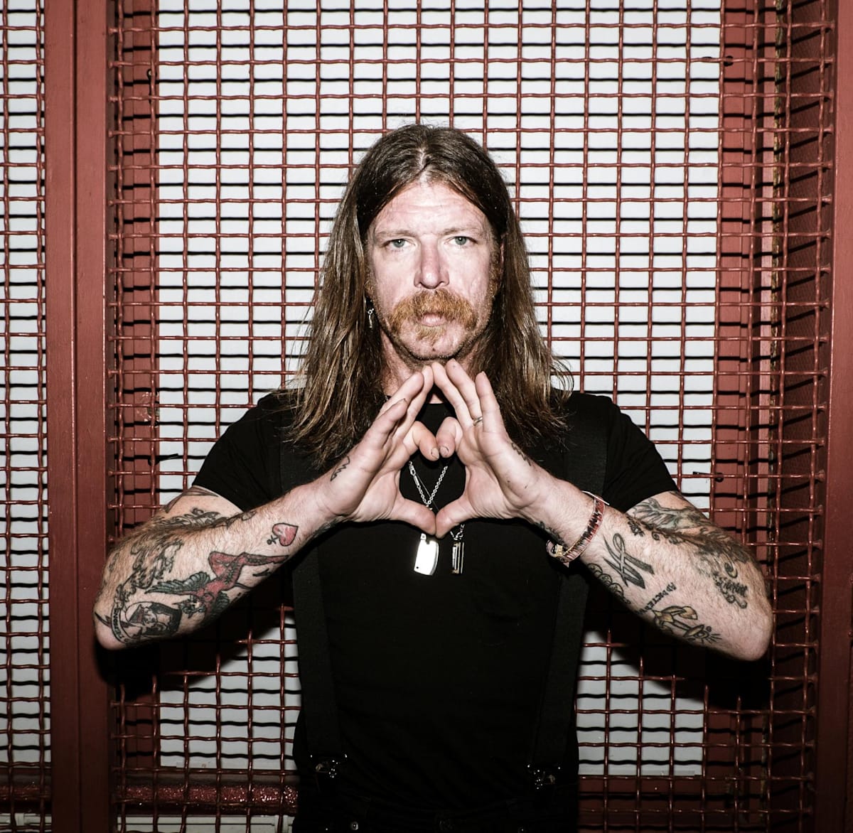 Jesse Hughes tattooed arms and hand portrait