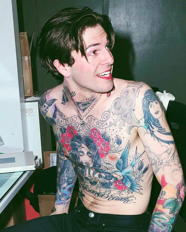 Jesse Rutherford tattoos: A close torso image clearly shows the LET GO AND LET GOD lettering, triangular eye and surrounding chest linework.
