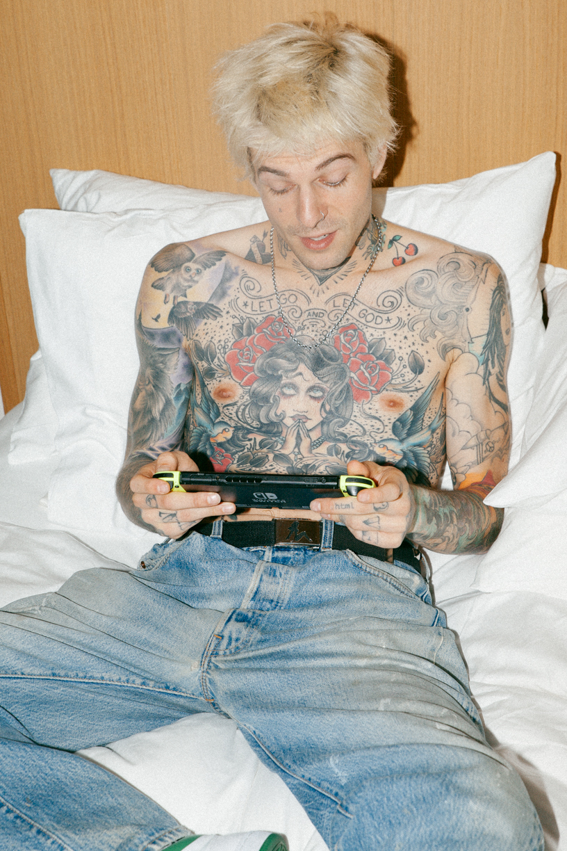 Jesse Rutherford tattoos: Office Magazine portrait clearly shows Jesse Rutherford's chest portrait, red roses, blue birds and upper-chest lettering.
