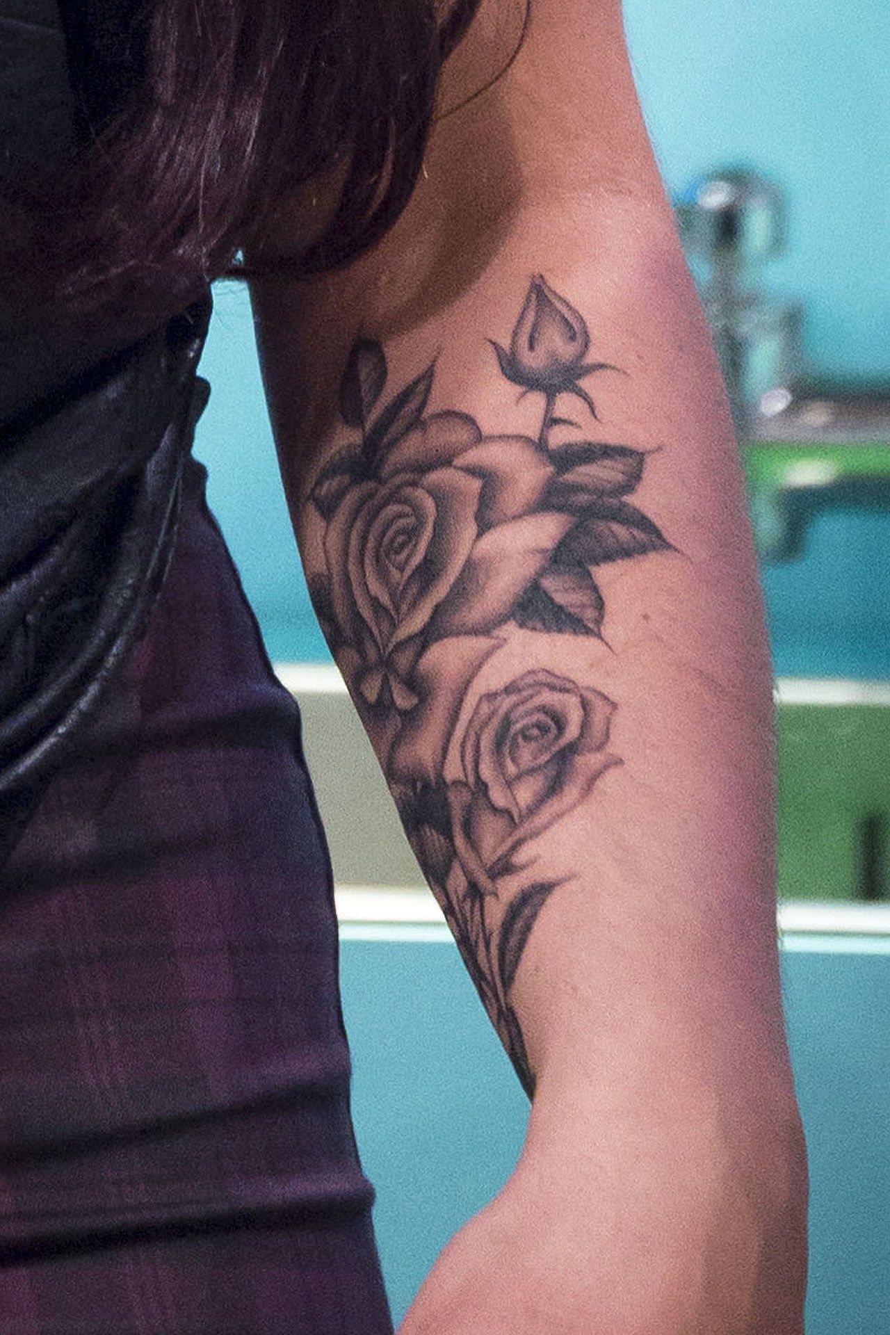 Jesy Nelson tattoos: Rose-and-thorn arm tattoo close view