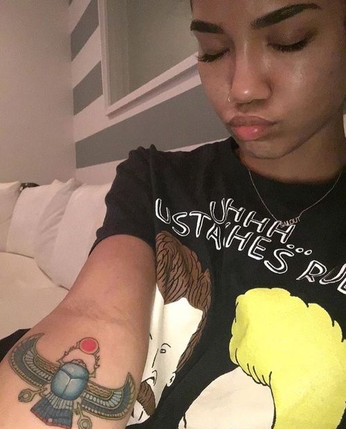 Jhene Aiko scarab forearm tattoo