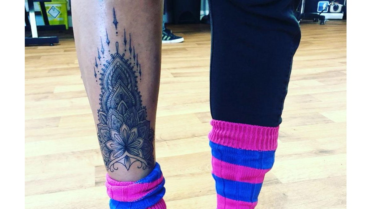 Jodie Marsh tattoos: right-shin black-ink floral temple tattoo