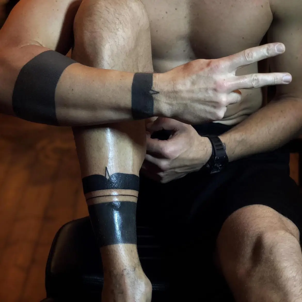 Joe Hart arm and leg bands in a seated photograph Joe Hart tattoos: arm and leg bands in a seated photograph