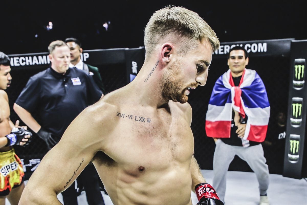 Jonathan Haggerty tattoos: side-angle post-fight view of the chest and neck lettering
