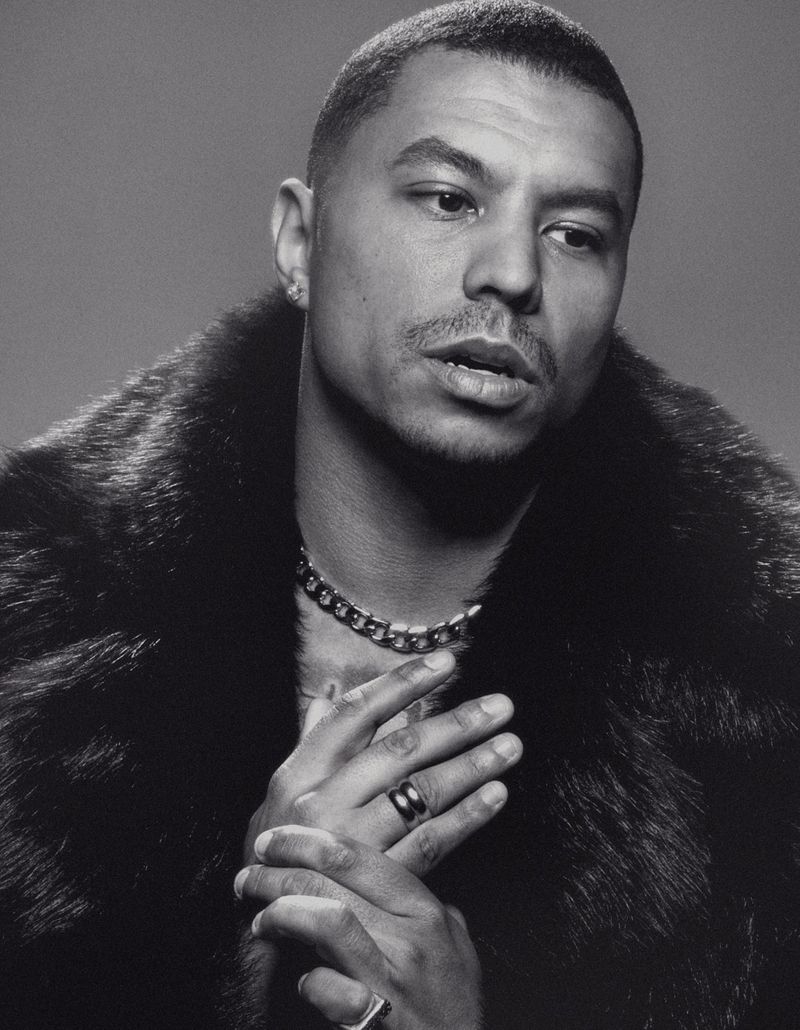 Jonathan Majors in a contextual photograph: Contextual fashion portrait for visual style discussion; explicitly not tattoo evidence.; not tattoo evidence