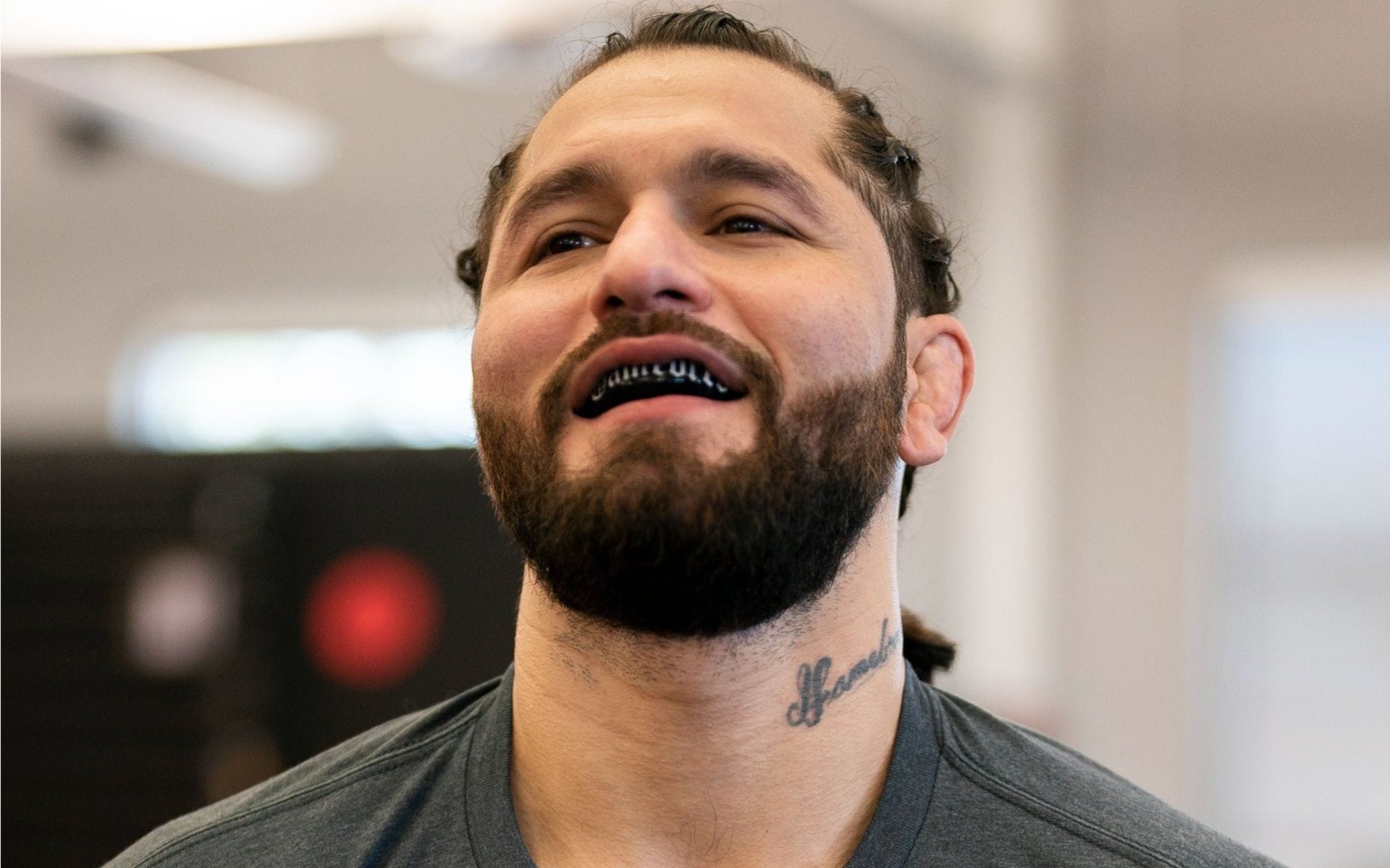 Jorge Masvidal tattoos: close face-visible view of the signature neck lettering