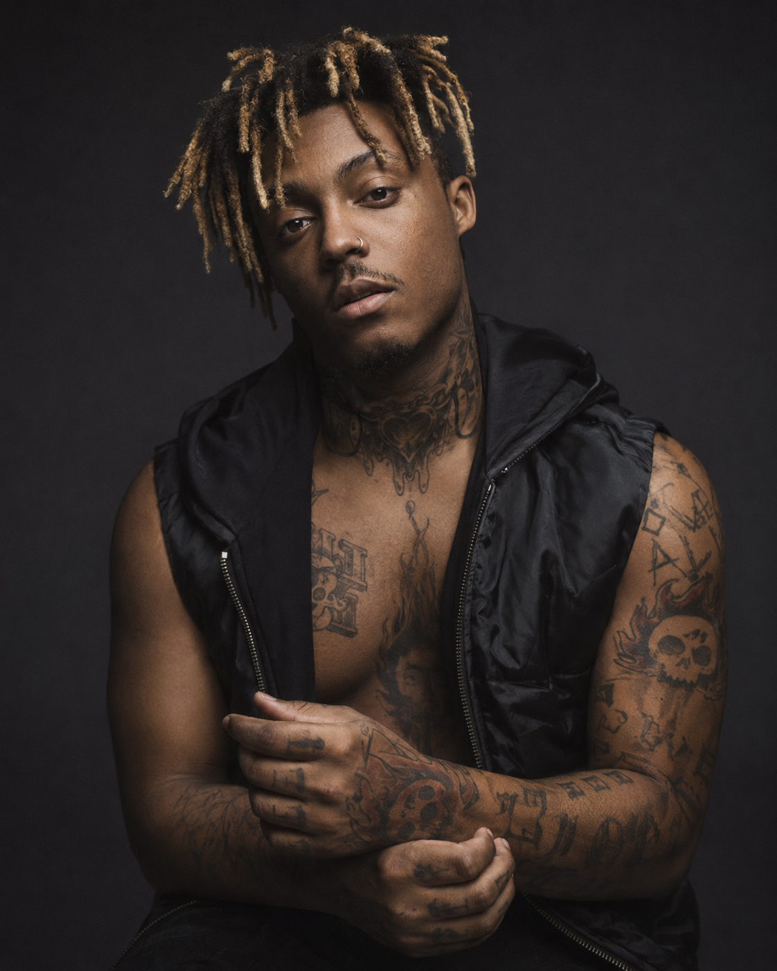 Juice WRLD tattoos: high-resolution studio portrait showing the chest, arms and hand tattoos