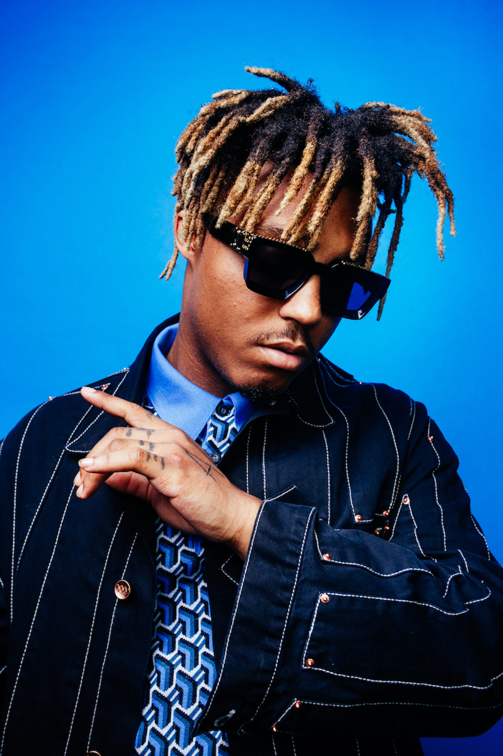 Juice WRLD tattoos: high-resolution portrait showing the finger lettering and hand marks