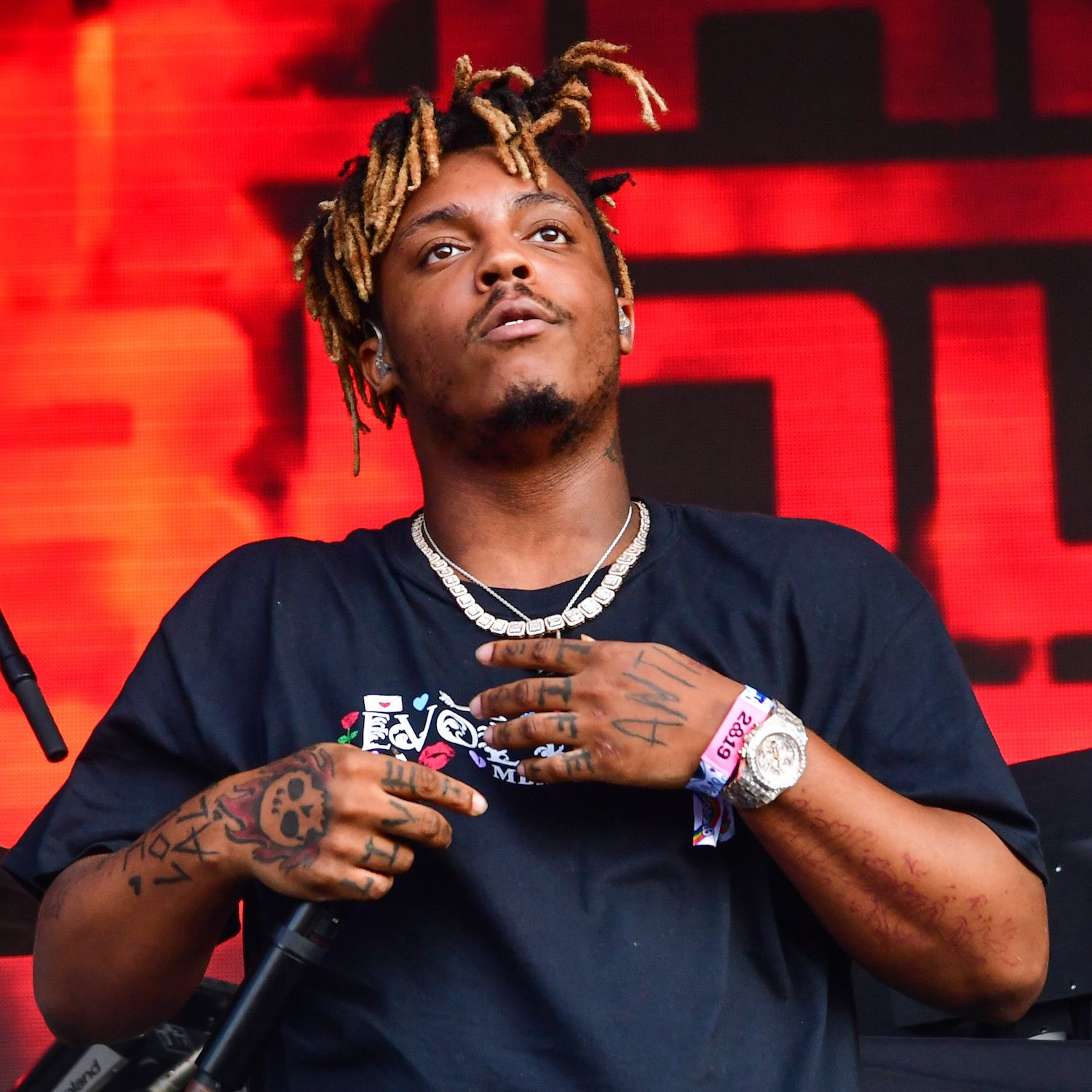 Juice WRLD tattoos: high-resolution live portrait showing the hands and arm tattoos in performance
