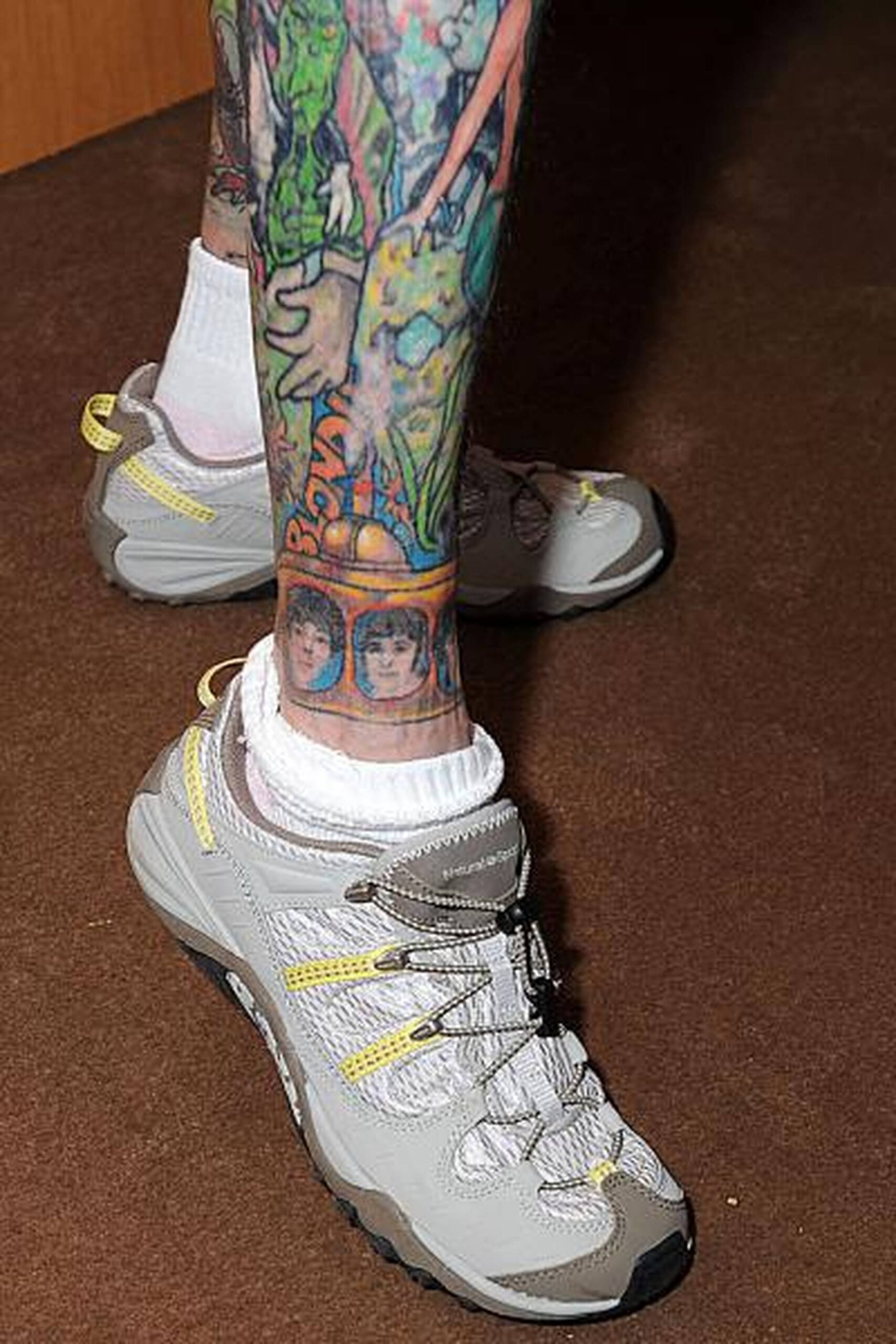 Julia Gnuse tattoos: Julia Gnuse colorful lower-leg tattoos, selected because the named tattoo areas are clearly visible in a distinct high-resolution photograph