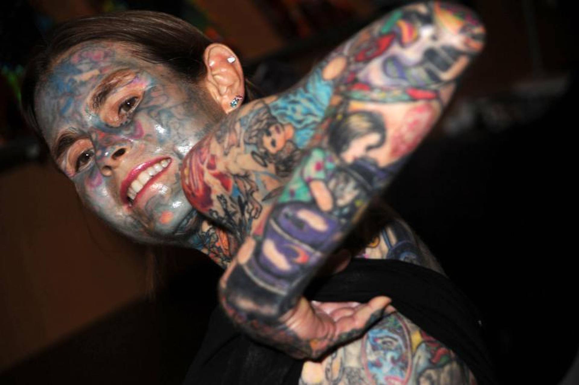 Julia Gnuse tattoos: Julia Gnuse face, neck and forearm tattoos, selected because the named tattoo areas are clearly visible in a distinct high-resolution photograph