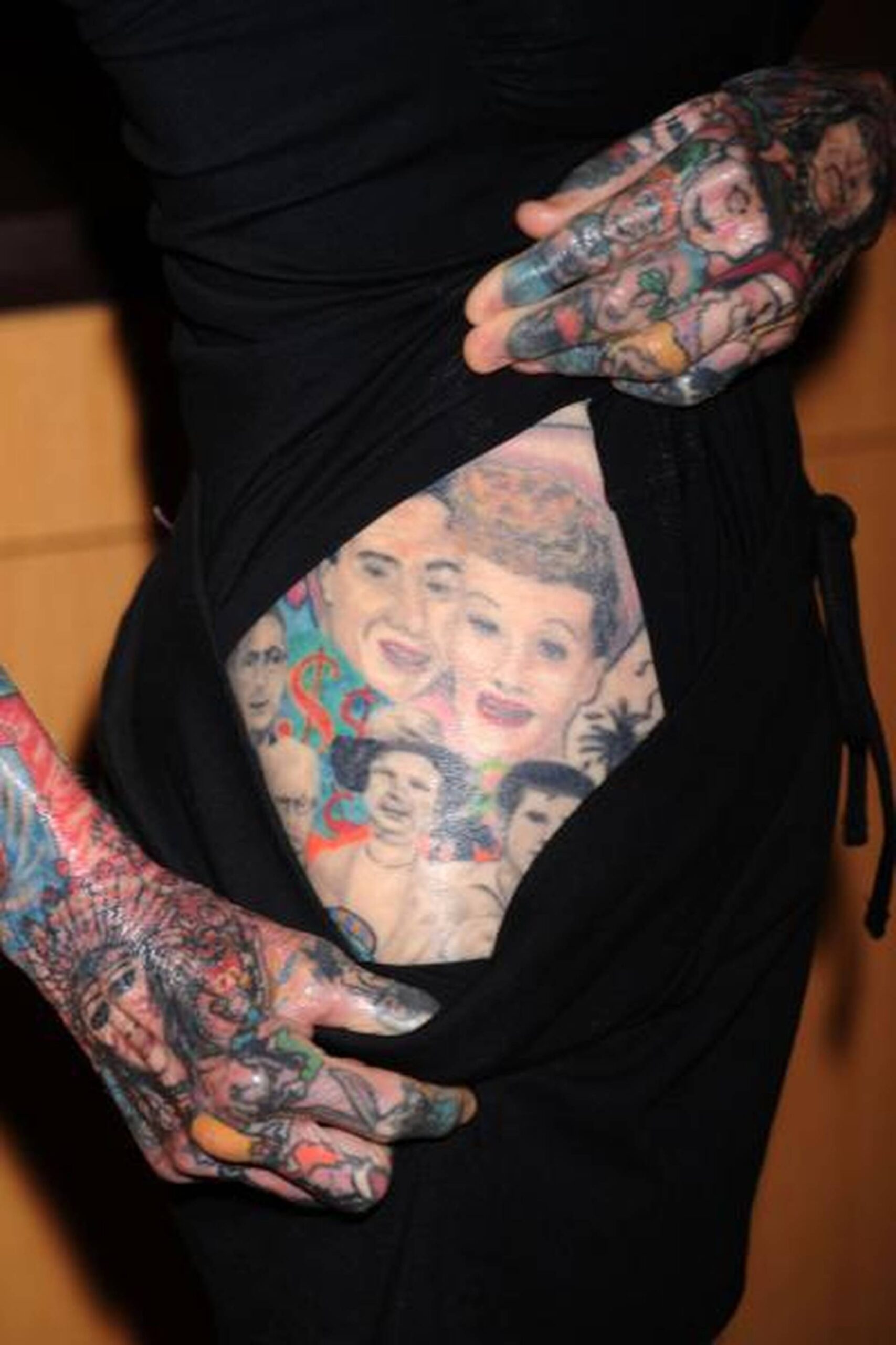 Julia Gnuse tattoos: Julia Gnuse hand and stomach portrait tattoos, selected because the named tattoo areas are clearly visible in a distinct high-resolution photograph