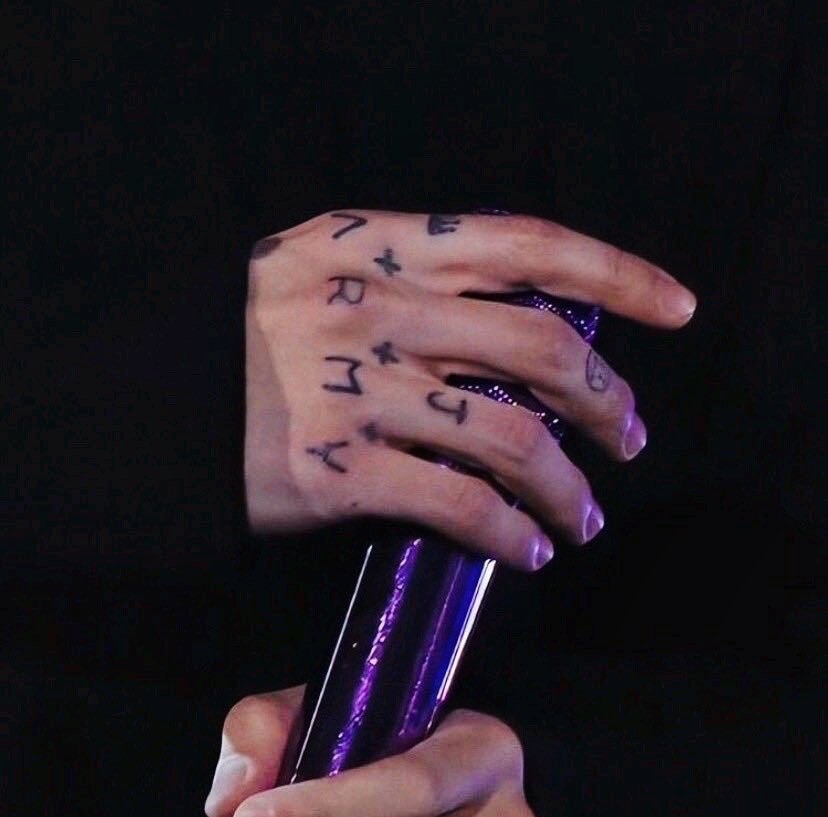 Jungkook showing his ARMY knuckle tattoos