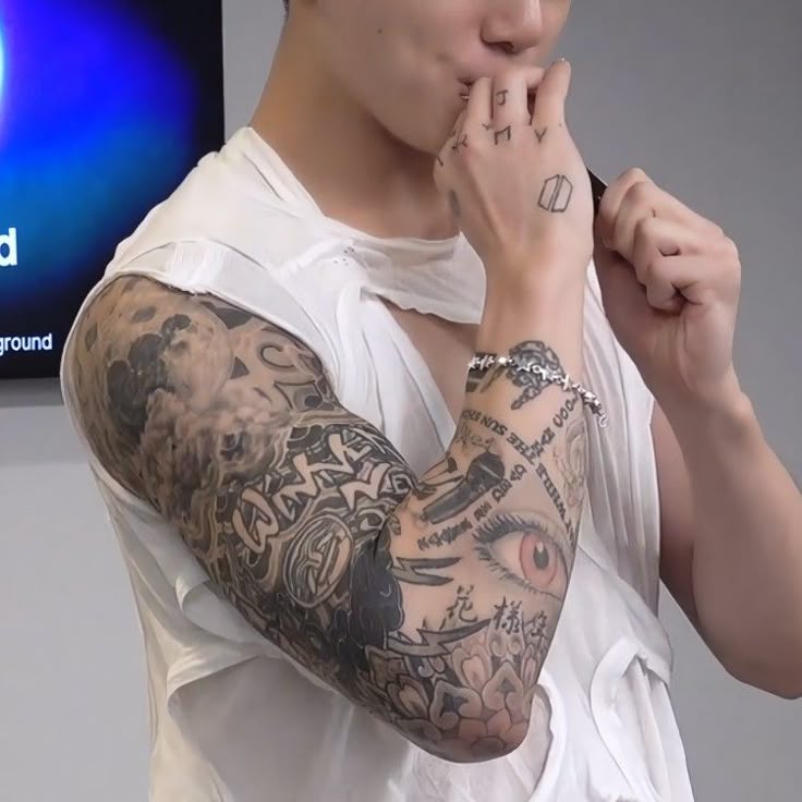 Jungkook showing his full arm sleeve tattoos