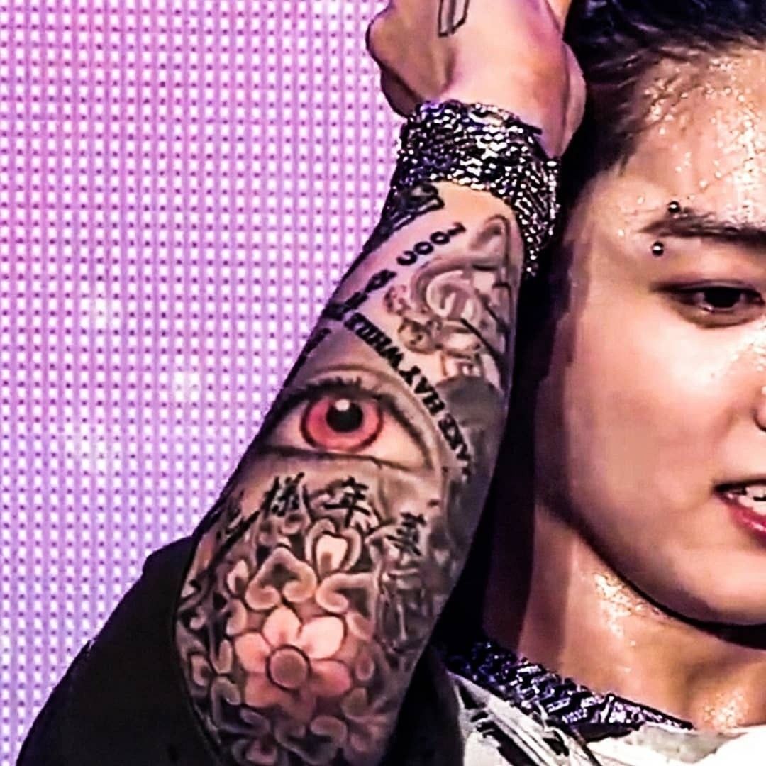 Jungkook red eye and floral arm tattoos