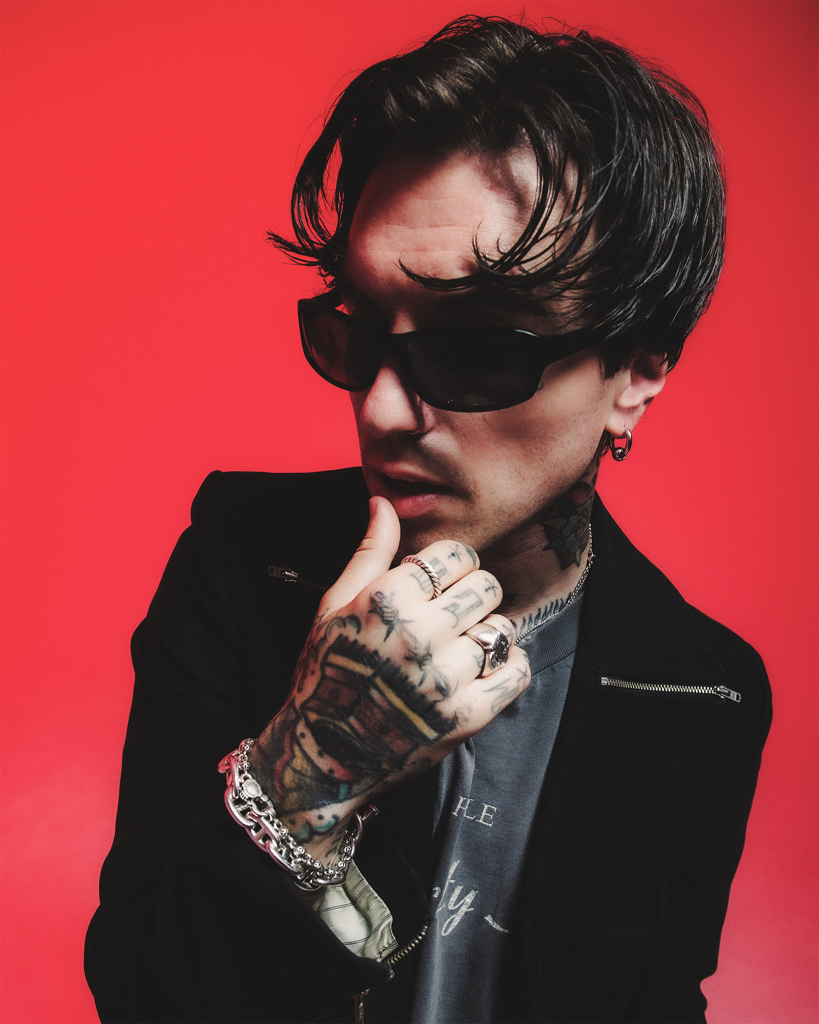 Jutes showing hand and neck tattoos in a Revolver portrait Jutes tattoos: close Revolver portrait showing the tattooed hand, fingers and neck in the same frame