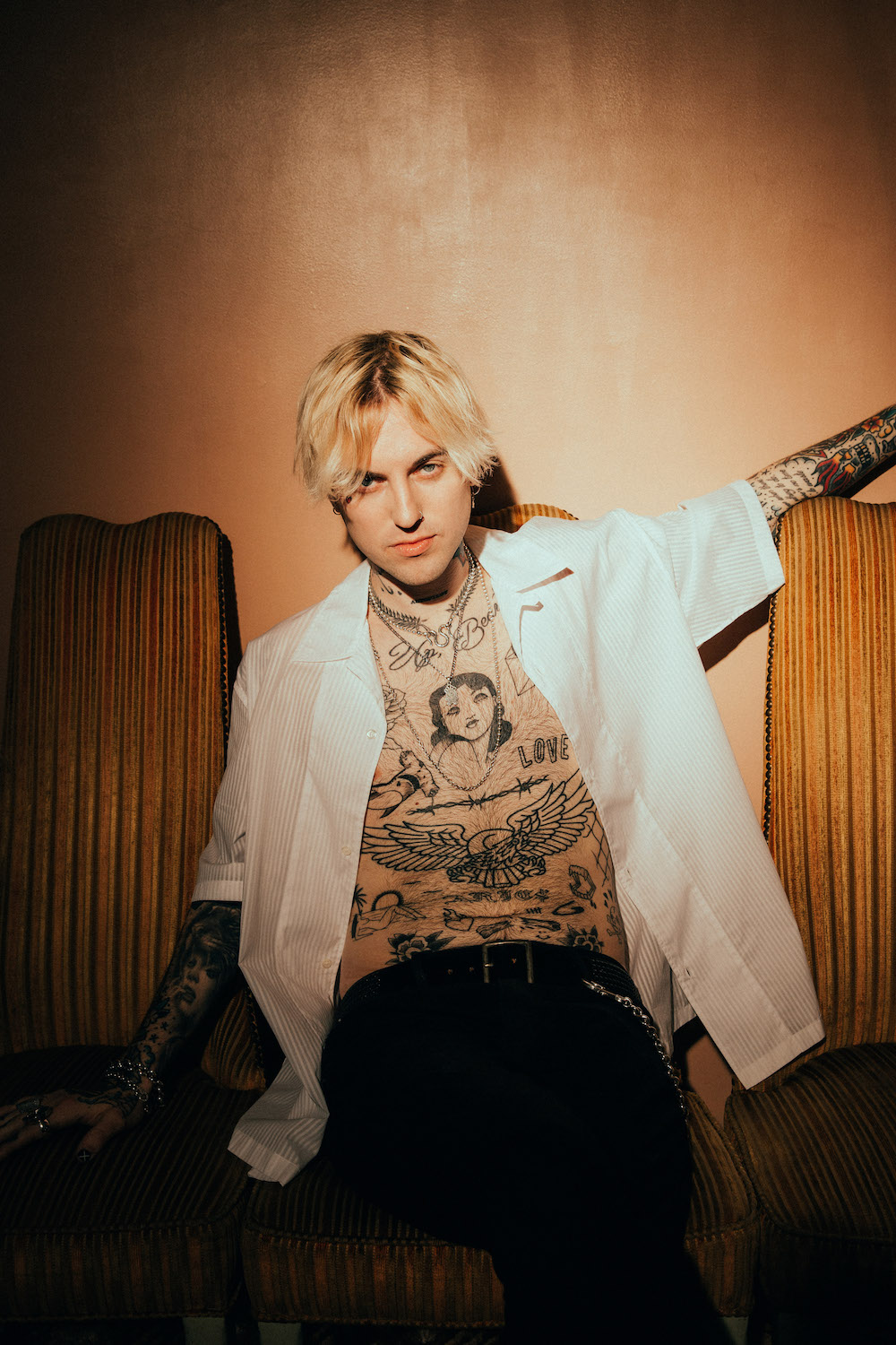 Jutes showing chest and arm tattoos in a Hype Magazine portrait Jutes tattoos: editorial portrait exposing the chest, arms and small symbols discussed in Jutes' quarantine account