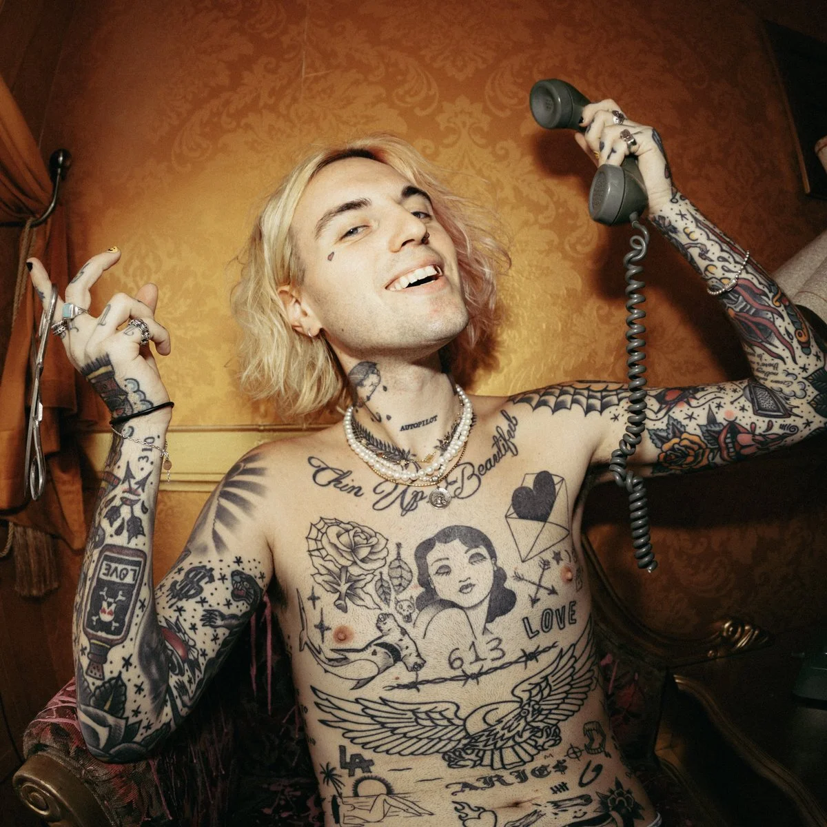 Jutes shirtless with shoulder, chest and sleeve tattoos visible Jutes tattoos: shirtless editorial portrait showing the shoulder, chest and sleeve field where the documented bear sits