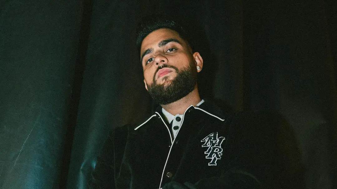 Karan Aujla in a contextual photograph: Promotional context; not tattoo evidence