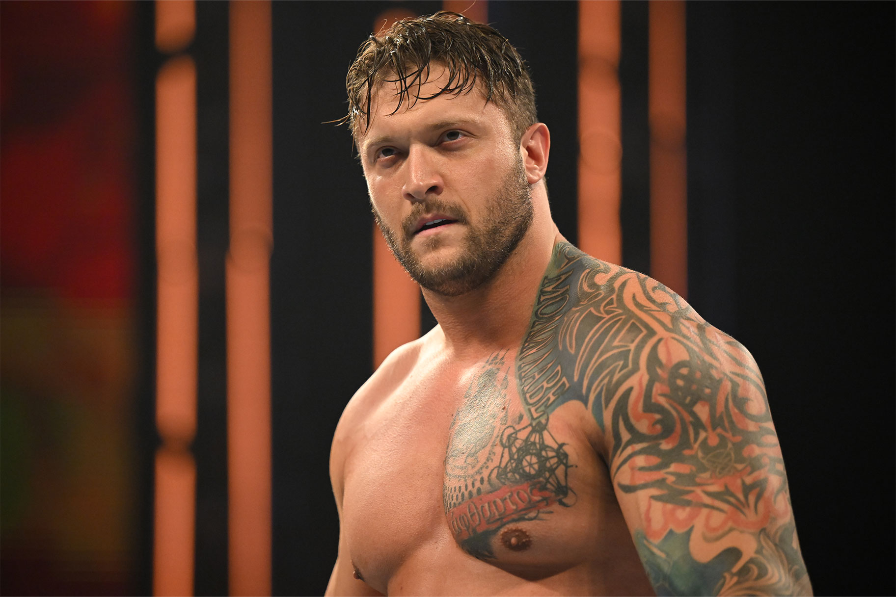 Karrion Kross tattoos: Karrion Kross chest lettering and upper-arm tattoos
