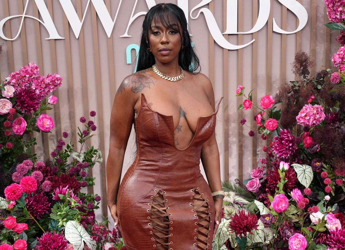 Kash Doll tattoos: Genuine high-resolution event photograph showing shoulder and chest tattoos.