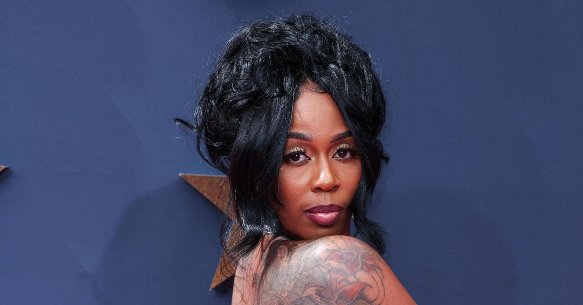Kash Doll tattoos: Genuine high-resolution red-carpet photograph showing the shoulder flower tattoo.