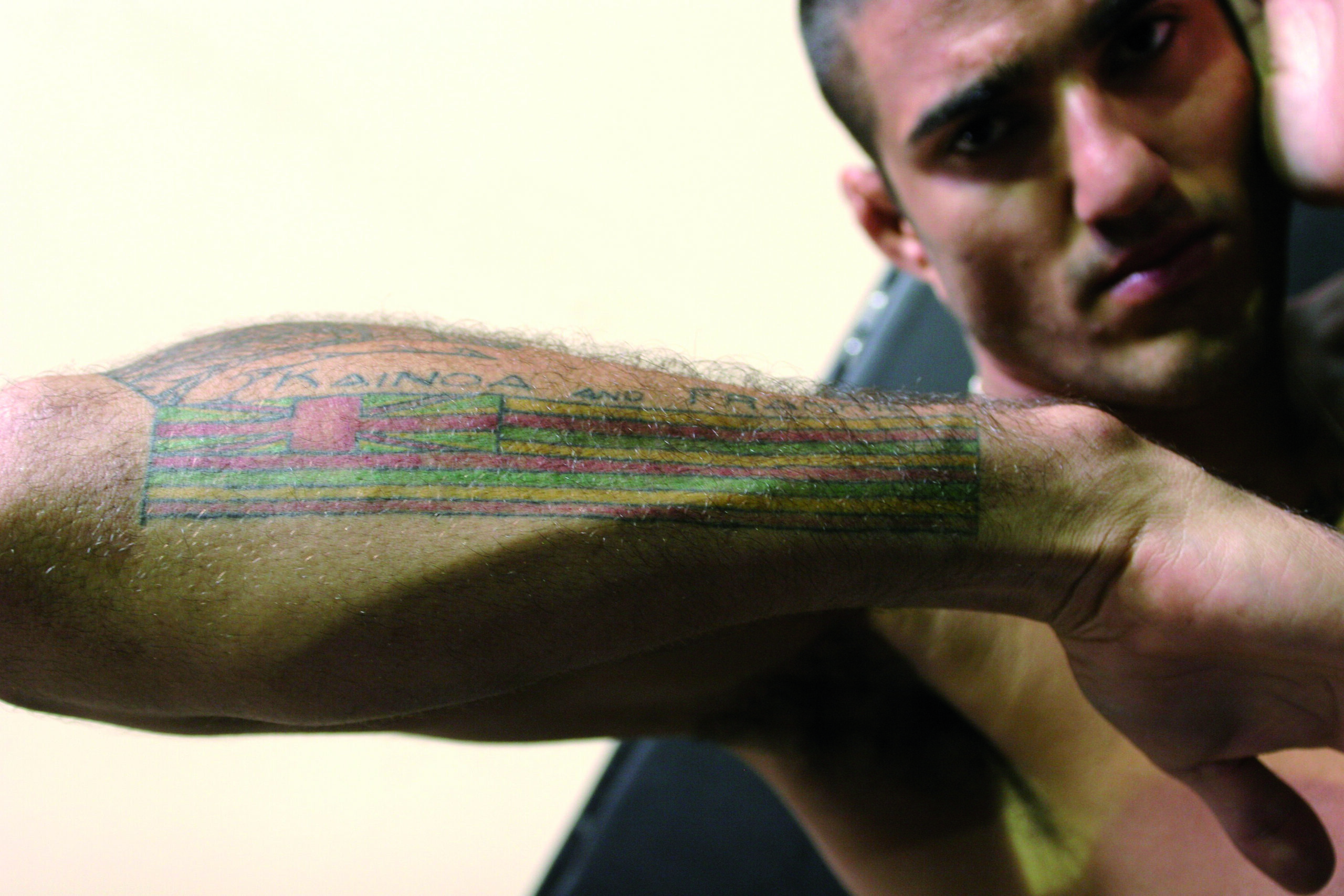 Kendall Grove: The red, gold and green forearm flag Kendall Grove tattoos: The red, gold and green forearm flag