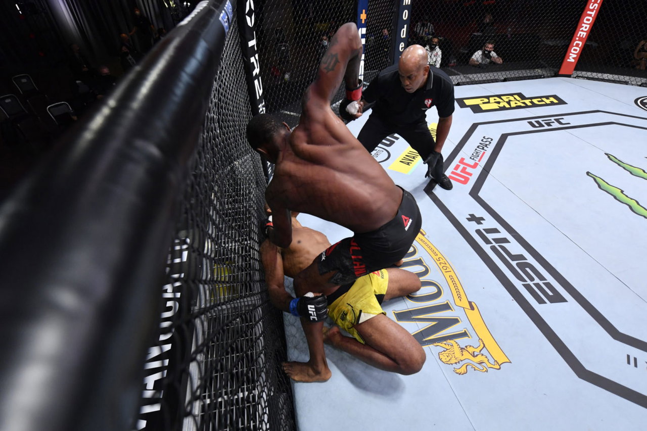 Kevin Holland tattoos: upper-back tattoo work visible during a fight