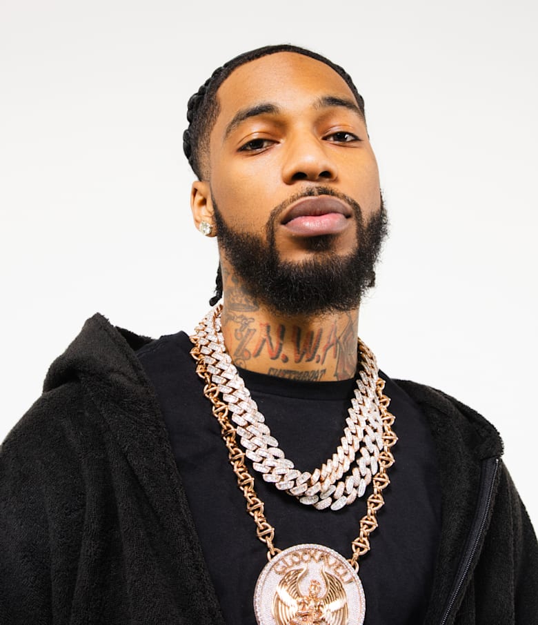 Key Glock tattoos: front neck lettering beneath the beard