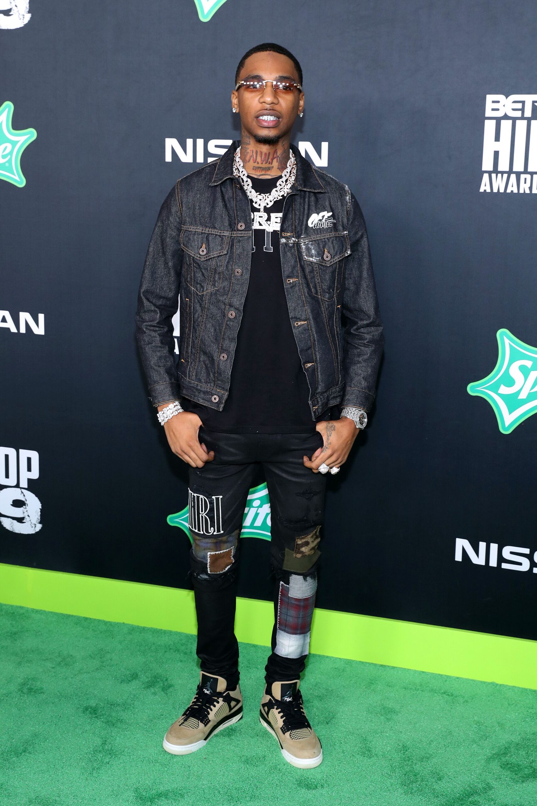 Key Glock tattoos: neck lettering and hand ink in a full-body portrait