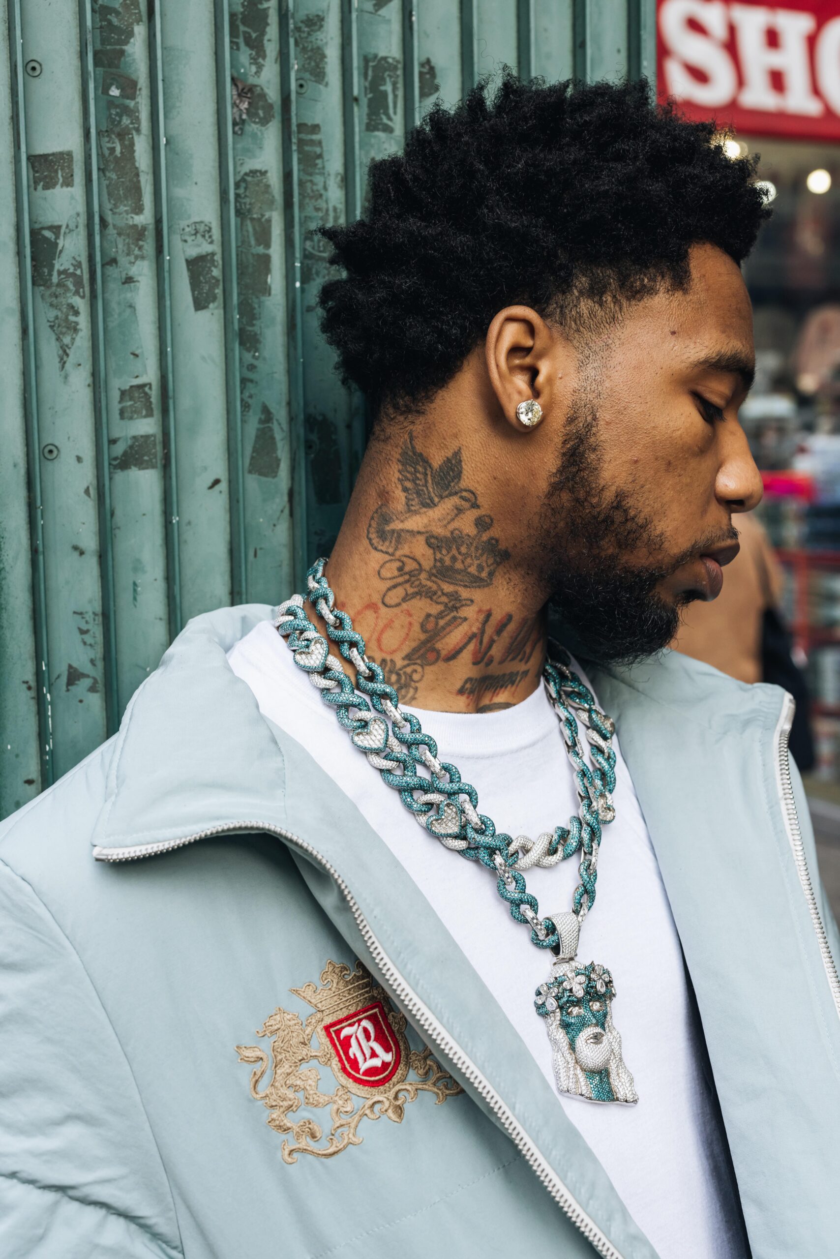 Key Glock tattoos: side neck lettering and shaded ink close-up