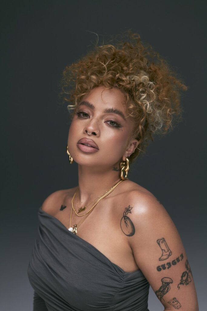 Kiana Ledé tattoos: Close portrait showing shoulder and upper-arm tattoo placement