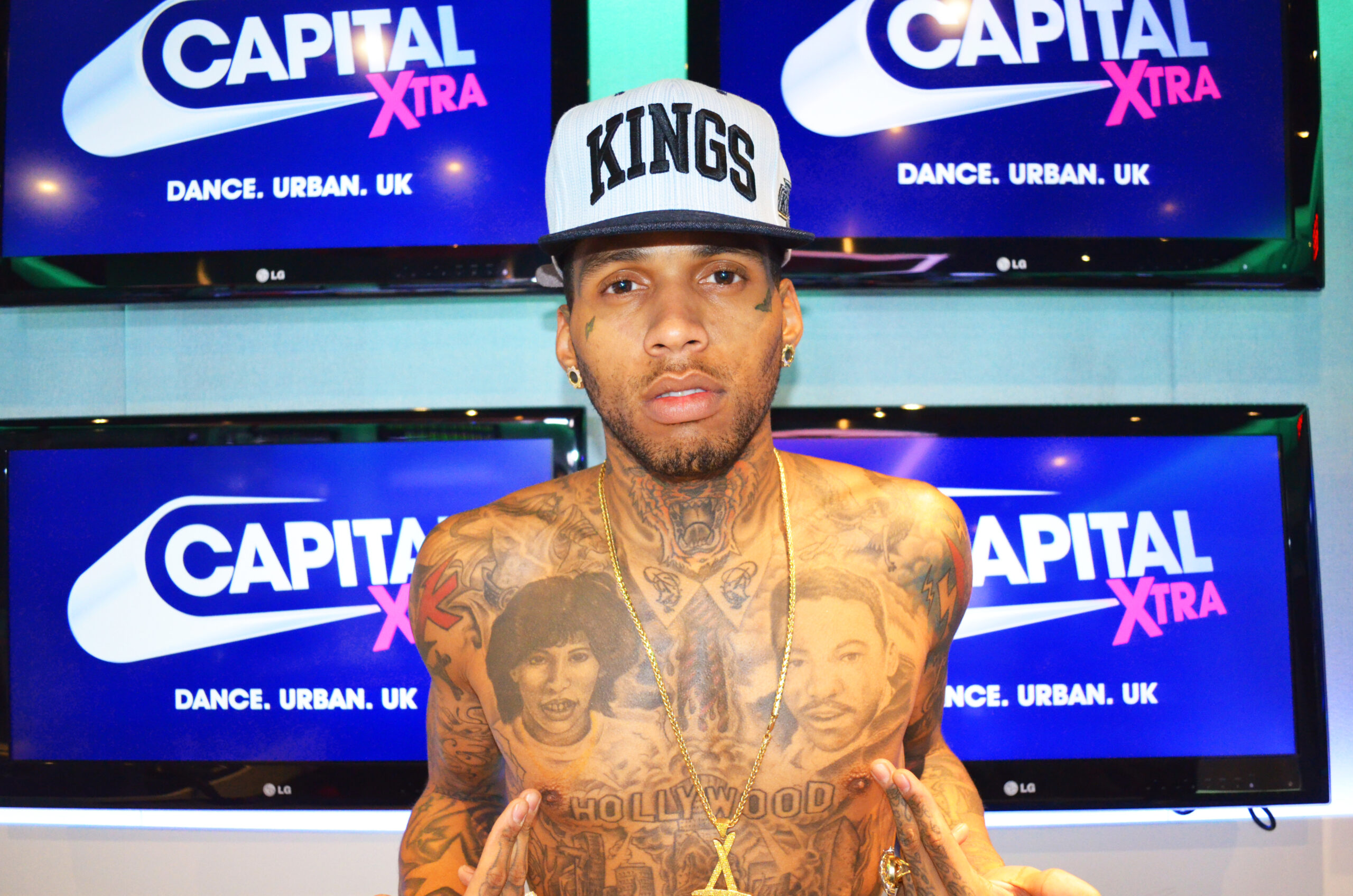 Kid Ink chest portrait tattoos