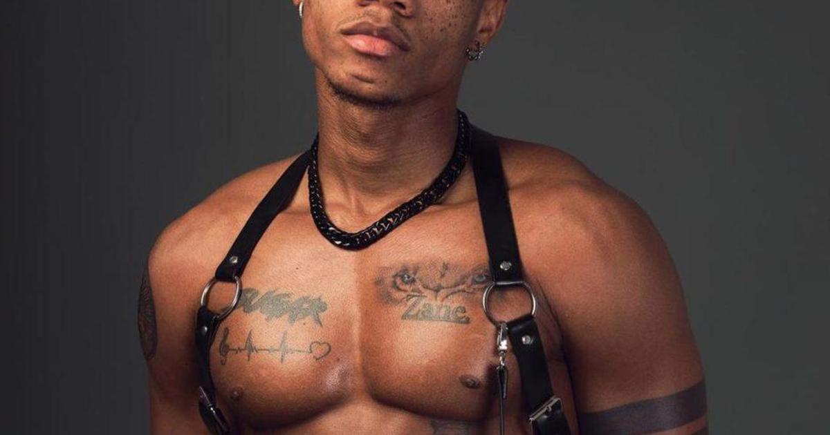 KiDi chest and arm tattoos KiDi tattoos: Genuine tattoo photograph showing KiDi's chest script, Zane tattoo, heartbeat line and arm bands.