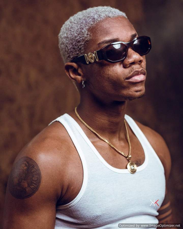 KiDi shoulder tattoo and arm bands KiDi tattoos: Genuine tattoo portrait showing KiDi's shoulder tattoo and wrapped upper-arm bands.