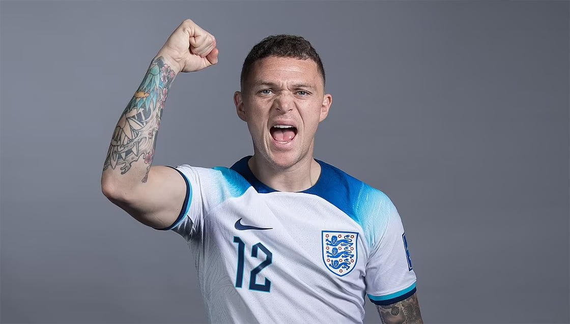 Kieran Trippier tattoos: Kieran Trippier raised-arm photograph showing flowers and geometric sleeve sections