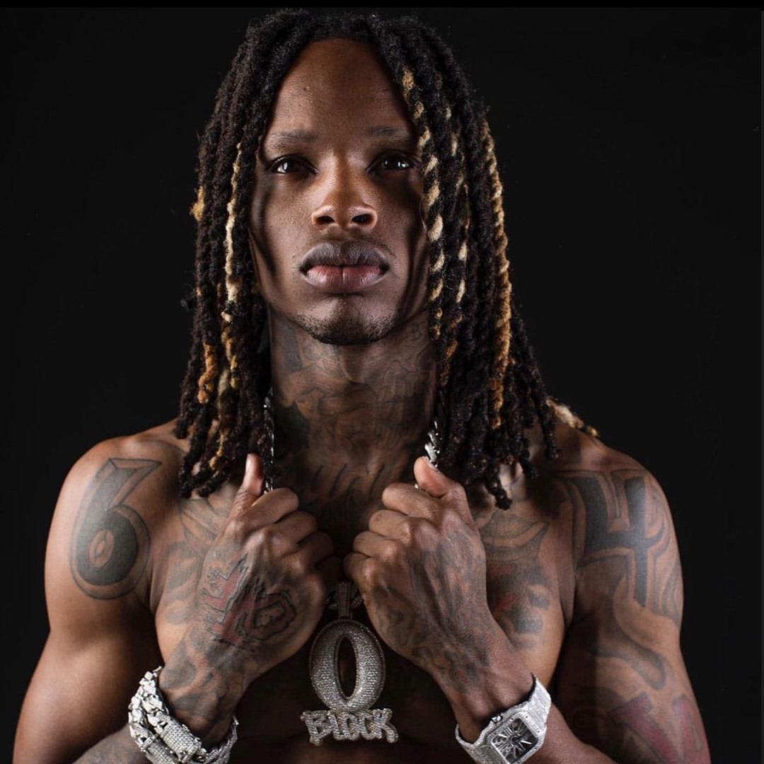 King Von tattoos: high-resolution close portrait showing the neck, shoulders and both hands with tattoo details visible